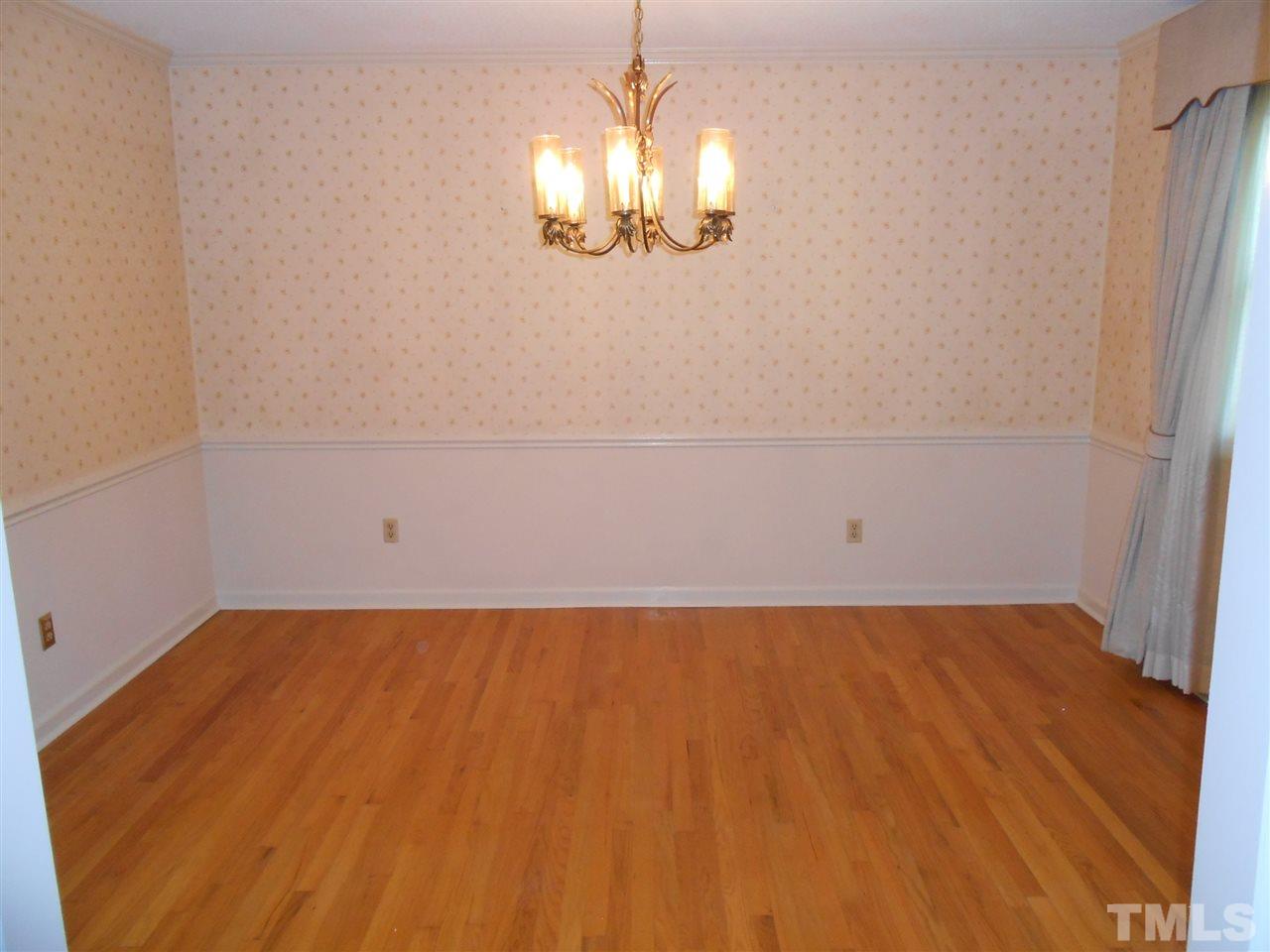 4508 Oak Park Road Raleigh, NC 27612 - Photo 10 of 24 a view of a room with wooden floor and chandelier