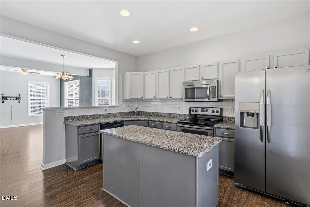 5531 Crabtree Park Court Raleigh, NC 27612 - Photo 10 of 41 a kitchen with stainless steel appliances granite countertop a refrigerator a stove a sink and a microwave