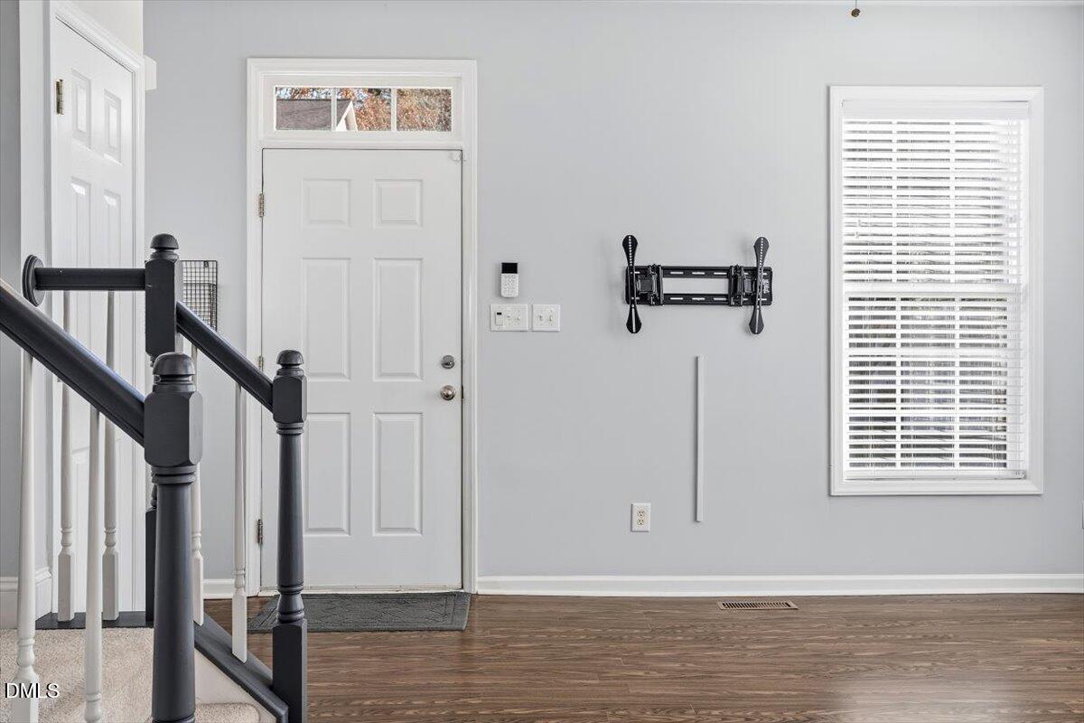 5531 Crabtree Park Court Raleigh, NC 27612 - Photo 16 of 41 a view of a hallway with wooden floor and staircase