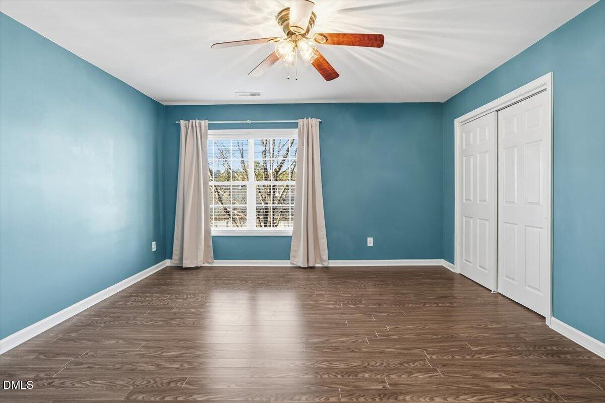 5531 Crabtree Park Court Raleigh, NC 27612 - Photo 19 of 41 a view of an empty room with window and wooden floor