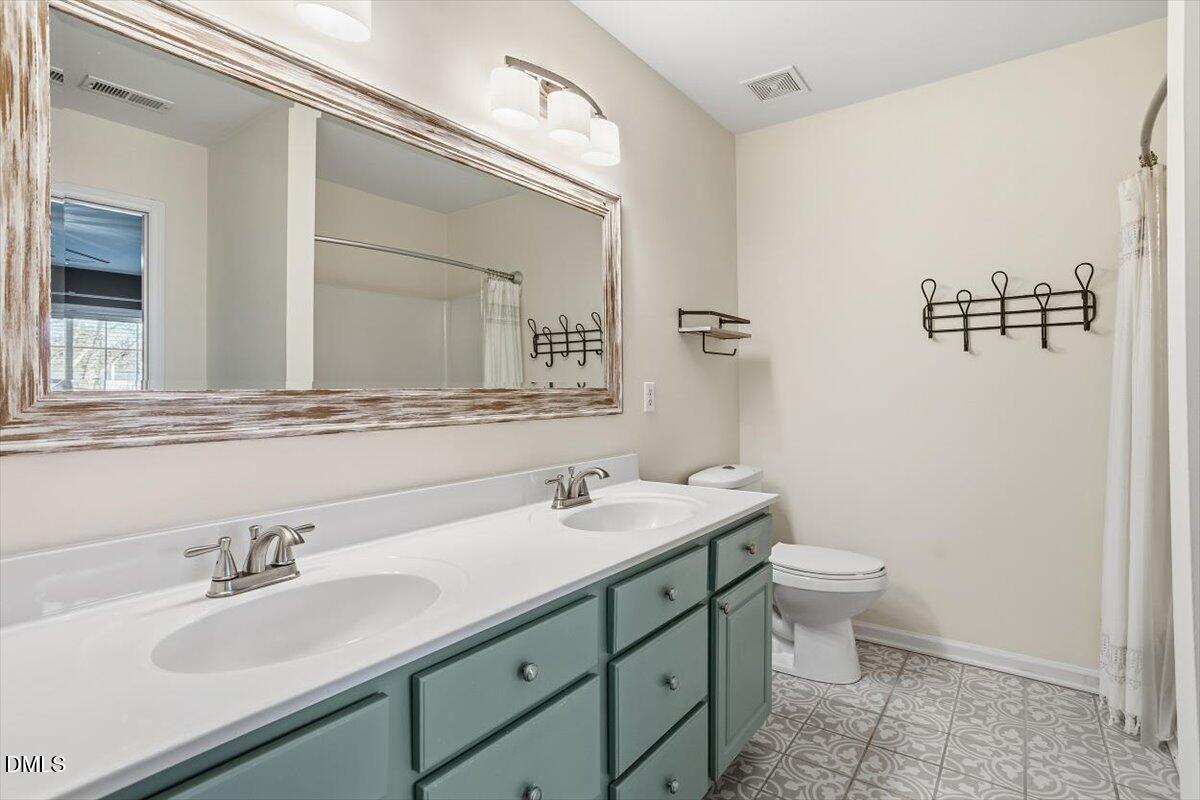 5531 Crabtree Park Court Raleigh, NC 27612 - Photo 22 of 41 a bathroom with a toilet sink and mirror