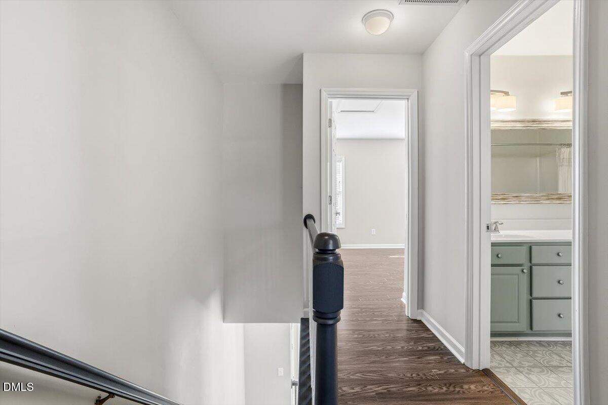 5531 Crabtree Park Court Raleigh, NC 27612 - Photo 25 of 41 a view of a hallway with wooden floor and staircase