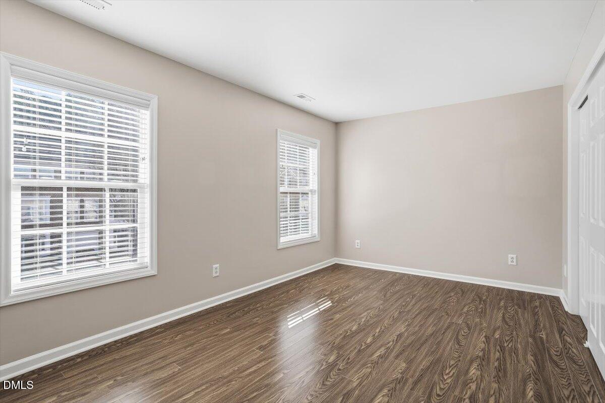 5531 Crabtree Park Court Raleigh, NC 27612 - Photo 27 of 41 a view of an empty room with wooden floor and a window