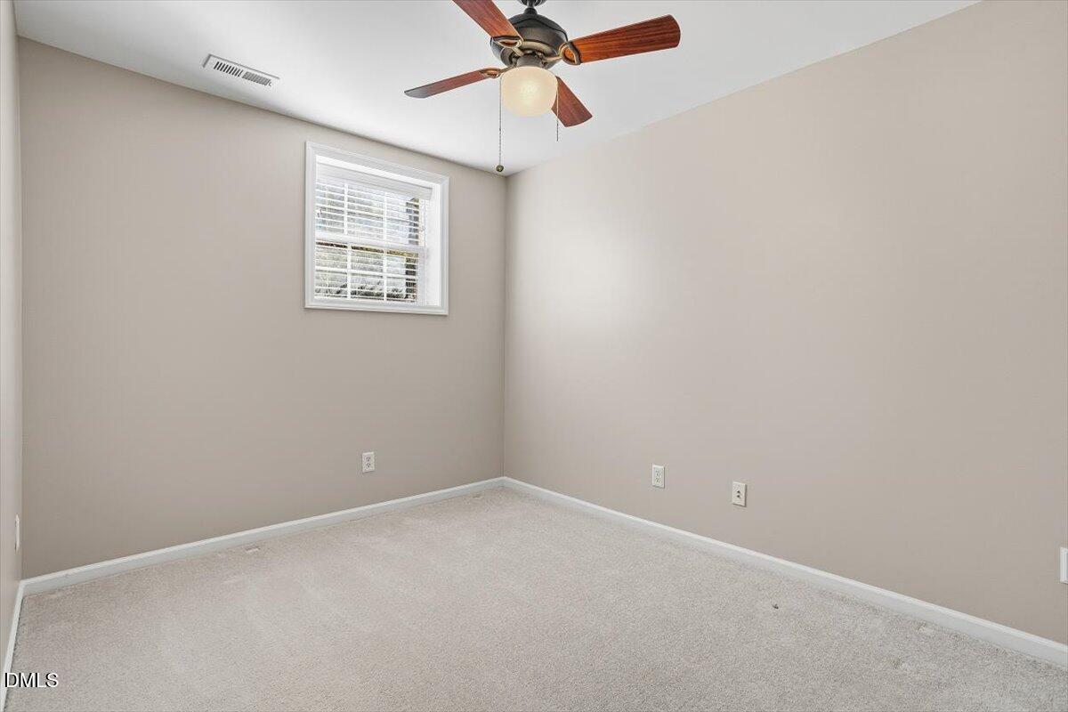 5531 Crabtree Park Court Raleigh, NC 27612 - Photo 29 of 41 an empty room with a window and a fan