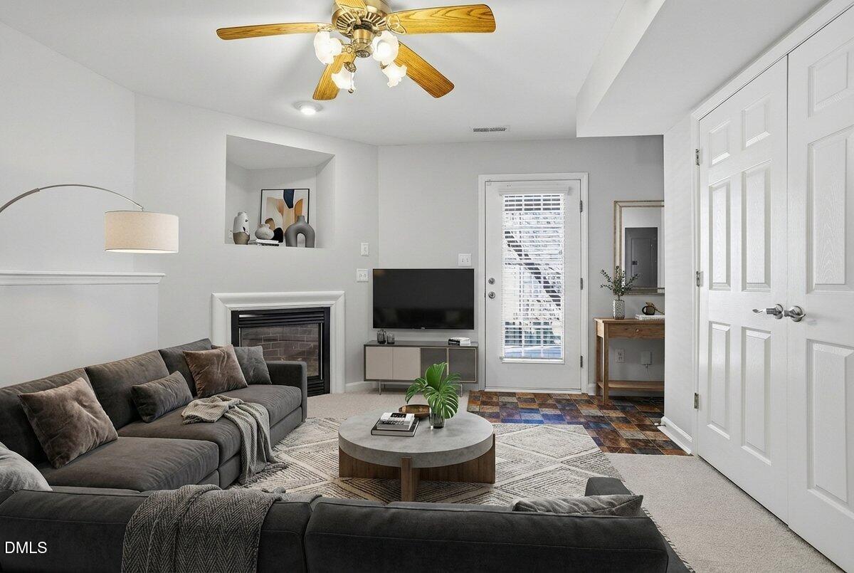 5531 Crabtree Park Court Raleigh, NC 27612 - Photo 31 of 41 a living room with furniture a fireplace and a flat screen tv
