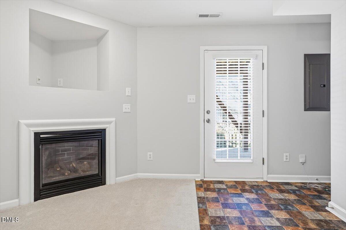 5531 Crabtree Park Court Raleigh, NC 27612 - Photo 33 of 41 a view of an empty room with a fireplace and a window
