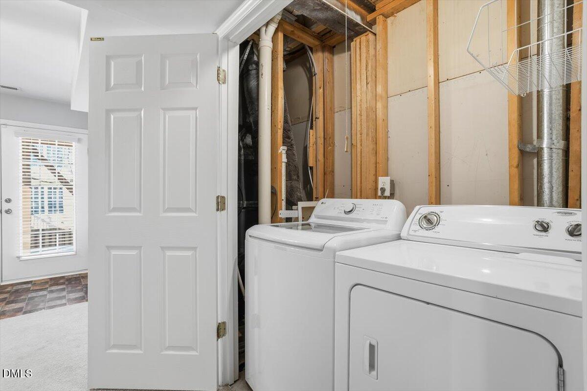 5531 Crabtree Park Court Raleigh, NC 27612 - Photo 34 of 41 a view of washer and dryer with bathroom in the background