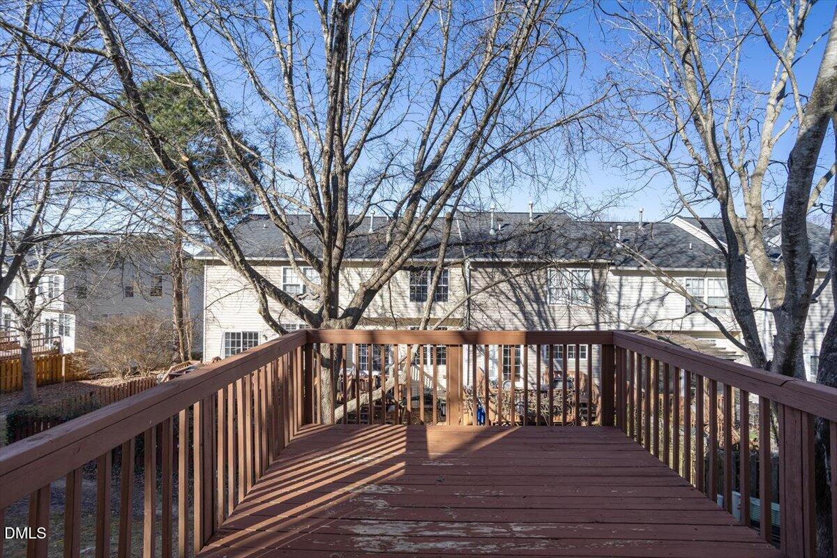 5531 Crabtree Park Court Raleigh, NC 27612 - Photo 35 of 41 a balcony with wooden floor and trees