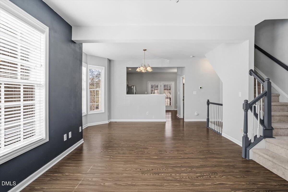 5531 Crabtree Park Court Raleigh, NC 27612 - Photo 3 of 41 a view of an empty room with wooden floor and a window