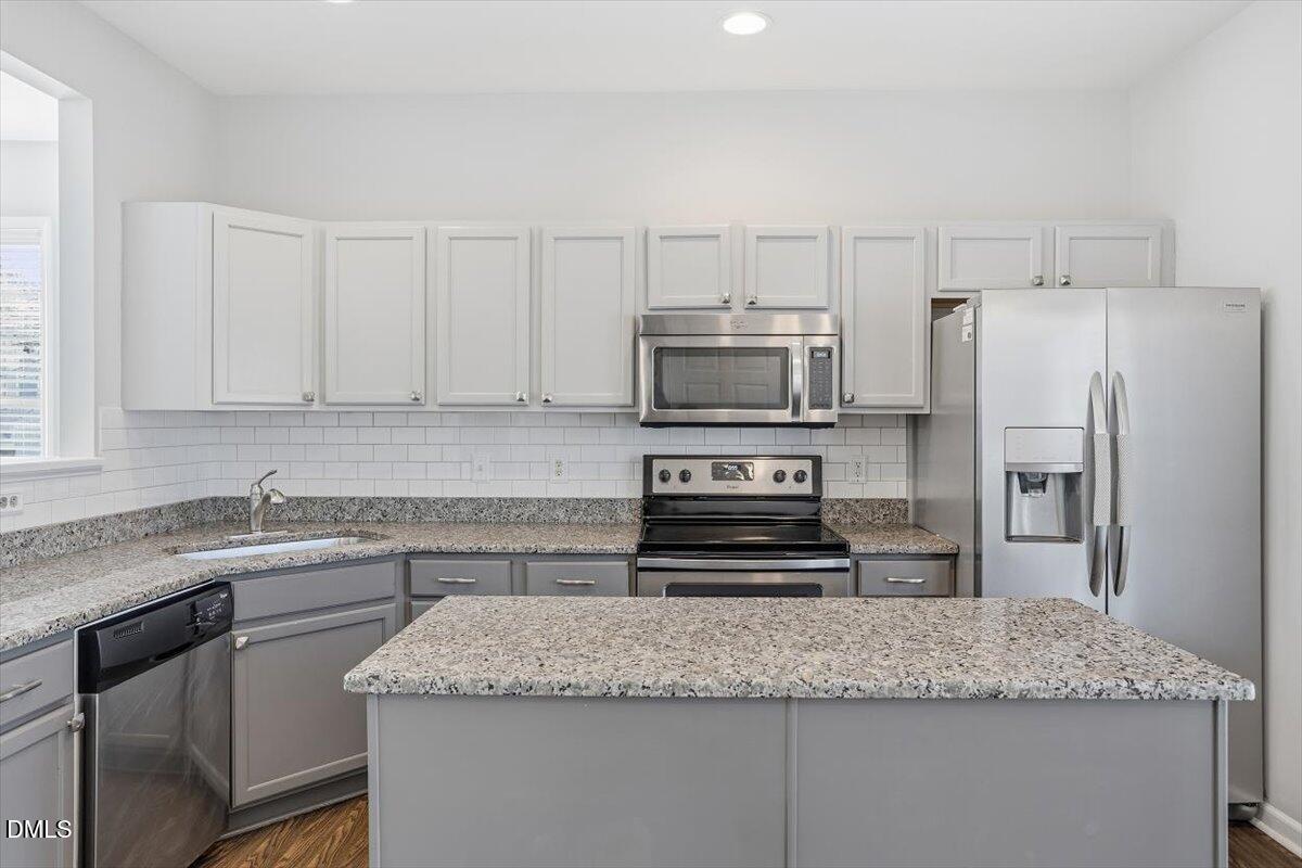 5531 Crabtree Park Court Raleigh, NC 27612 - Photo 7 of 41 a kitchen with stainless steel appliances granite countertop a sink stove and refrigerator
