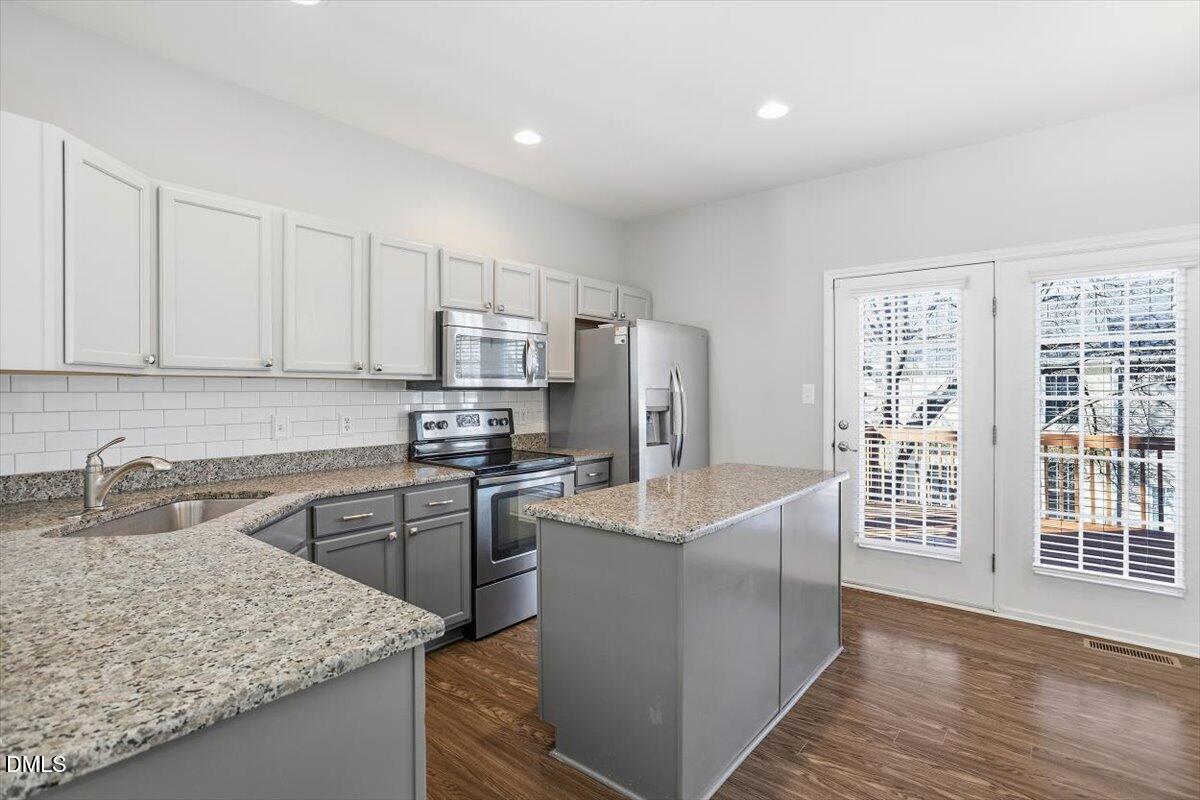5531 Crabtree Park Court Raleigh, NC 27612 - Photo 9 of 41 a kitchen with stainless steel appliances granite countertop a sink stove and refrigerator