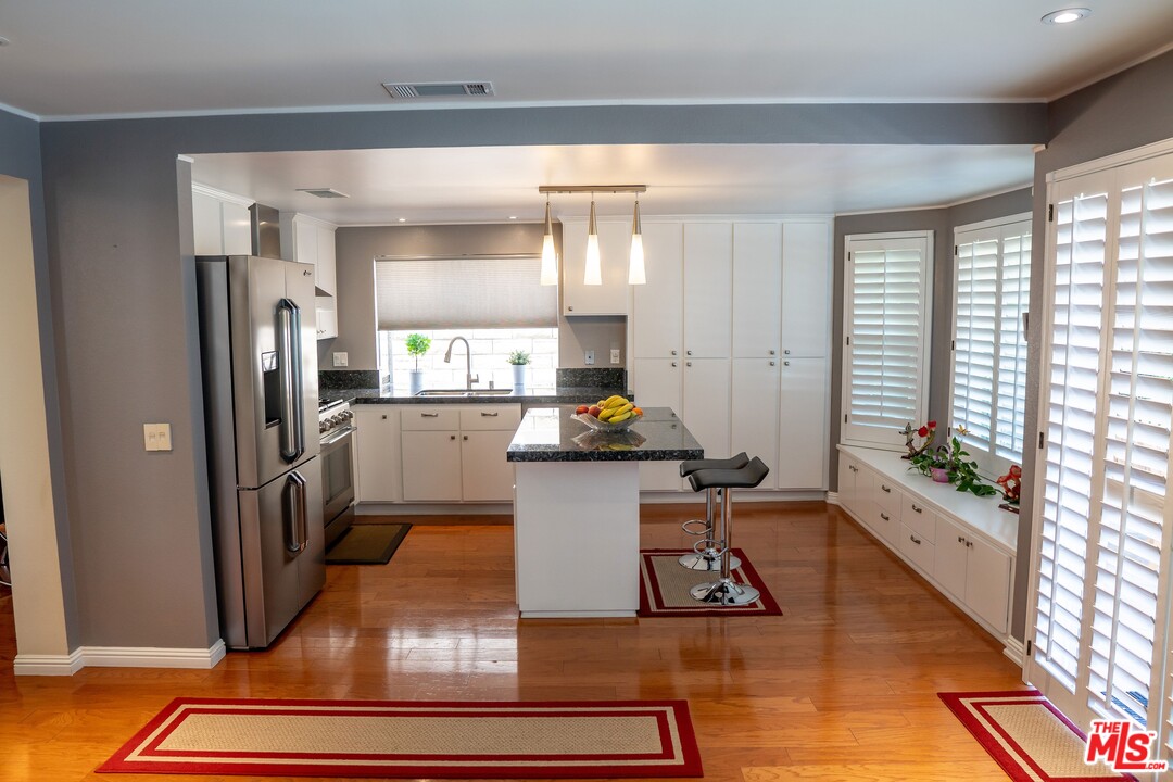 553 Fairfield Road Simi Valley, CA 93065 - Photo 19 of 49 a kitchen with a sink appliances cabinets and a counter top space