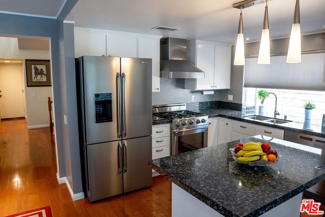 553 Fairfield Road Simi Valley, CA 93065 - Photo 20 of 49 a kitchen with stainless steel appliances granite countertop a sink refrigerator and microwave