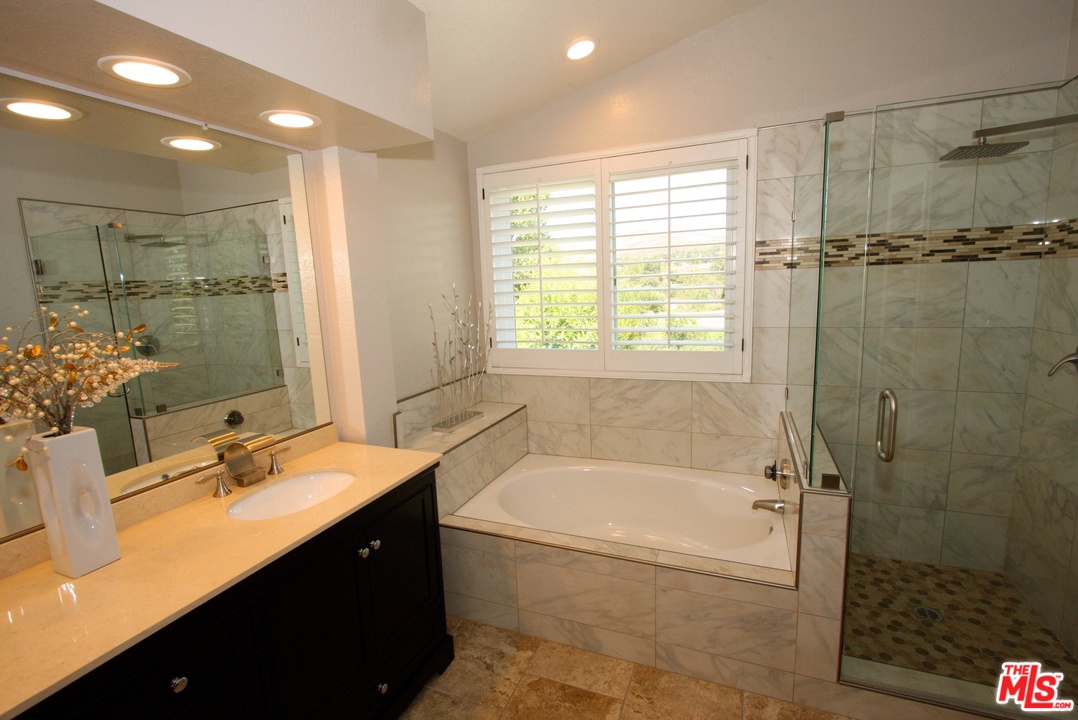 553 Fairfield Road Simi Valley, CA 93065 - Photo 25 of 49 a bathroom with a bathtub shower sink vanity and toilet