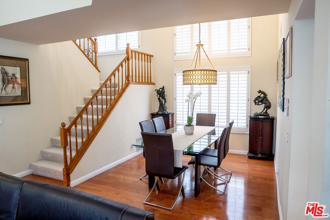 553 Fairfield Road Simi Valley, CA 93065 - Photo 9 of 49 a dining room with furniture a chandelier and wooden floor