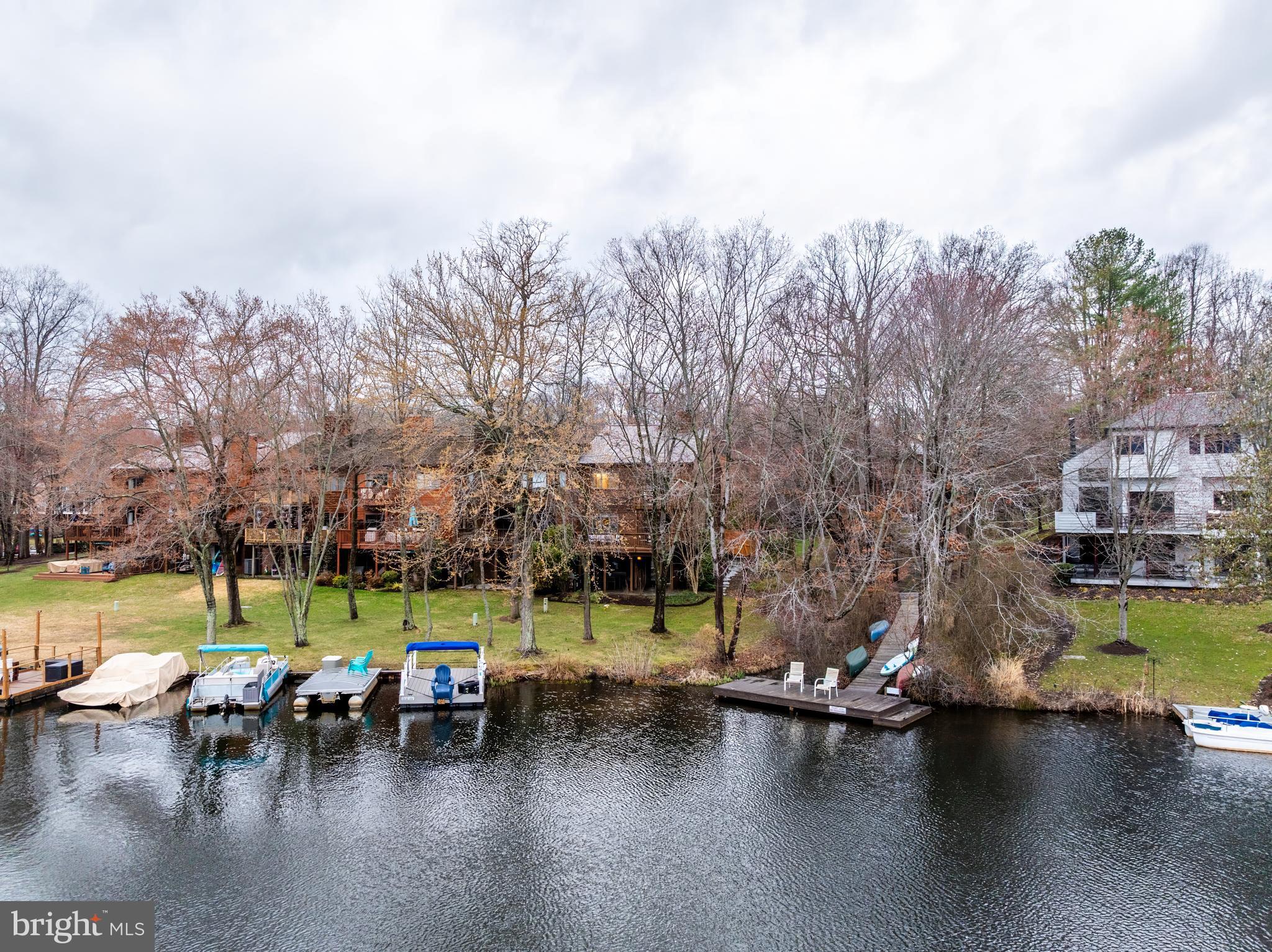2261 Cedar Cove Court Reston, VA 20191 - Photo 101 of 102 a view of swimming pool with outdoor seating and trees in the background