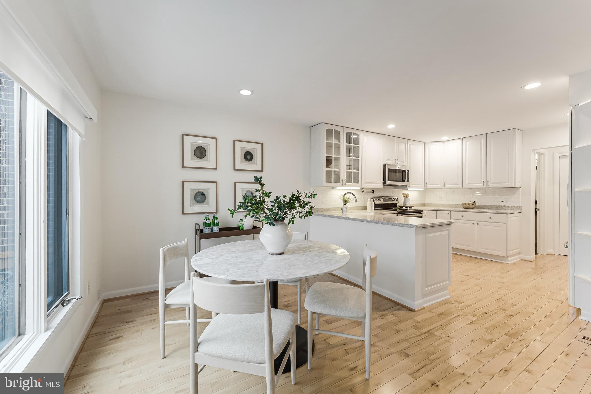 2261 Cedar Cove Court Reston, VA 20191 - Photo 25 of 102 a kitchen with kitchen island a dining table chairs cabinets and appliances