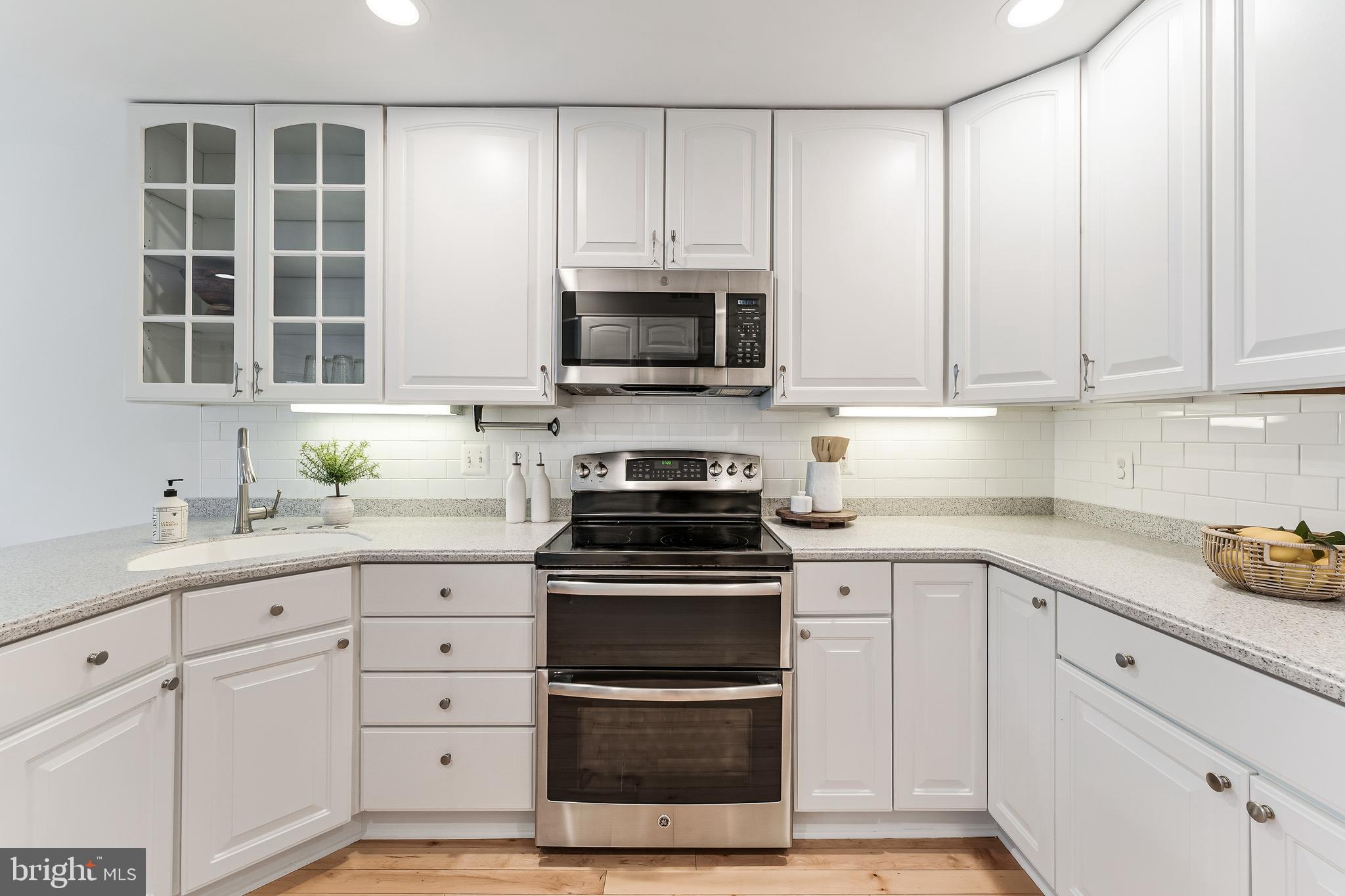 2261 Cedar Cove Court Reston, VA 20191 - Photo 32 of 102 a kitchen with granite countertop white cabinets and stainless steel appliances