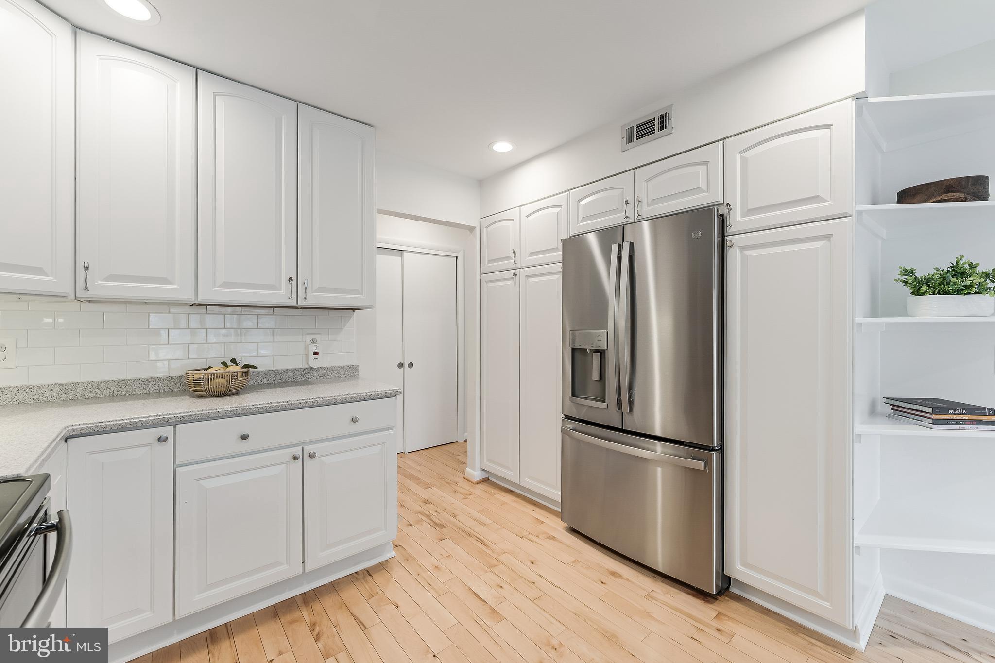 2261 Cedar Cove Court Reston, VA 20191 - Photo 33 of 102 a kitchen with granite countertop stainless steel appliances a refrigerator a sink and cabinets
