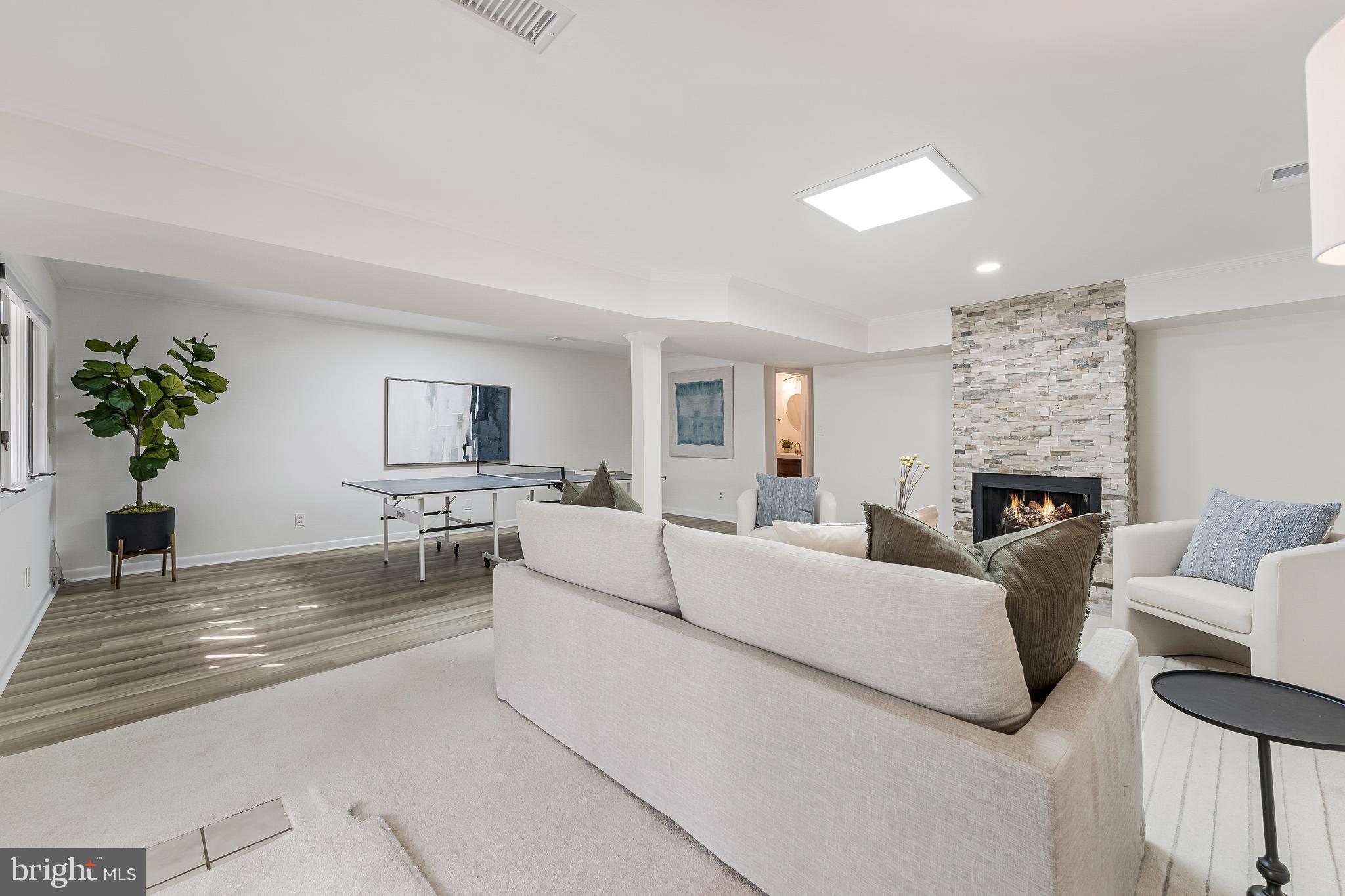 2261 Cedar Cove Court Reston, VA 20191 - Photo 64 of 102 a living room with furniture a fireplace and a potted plant