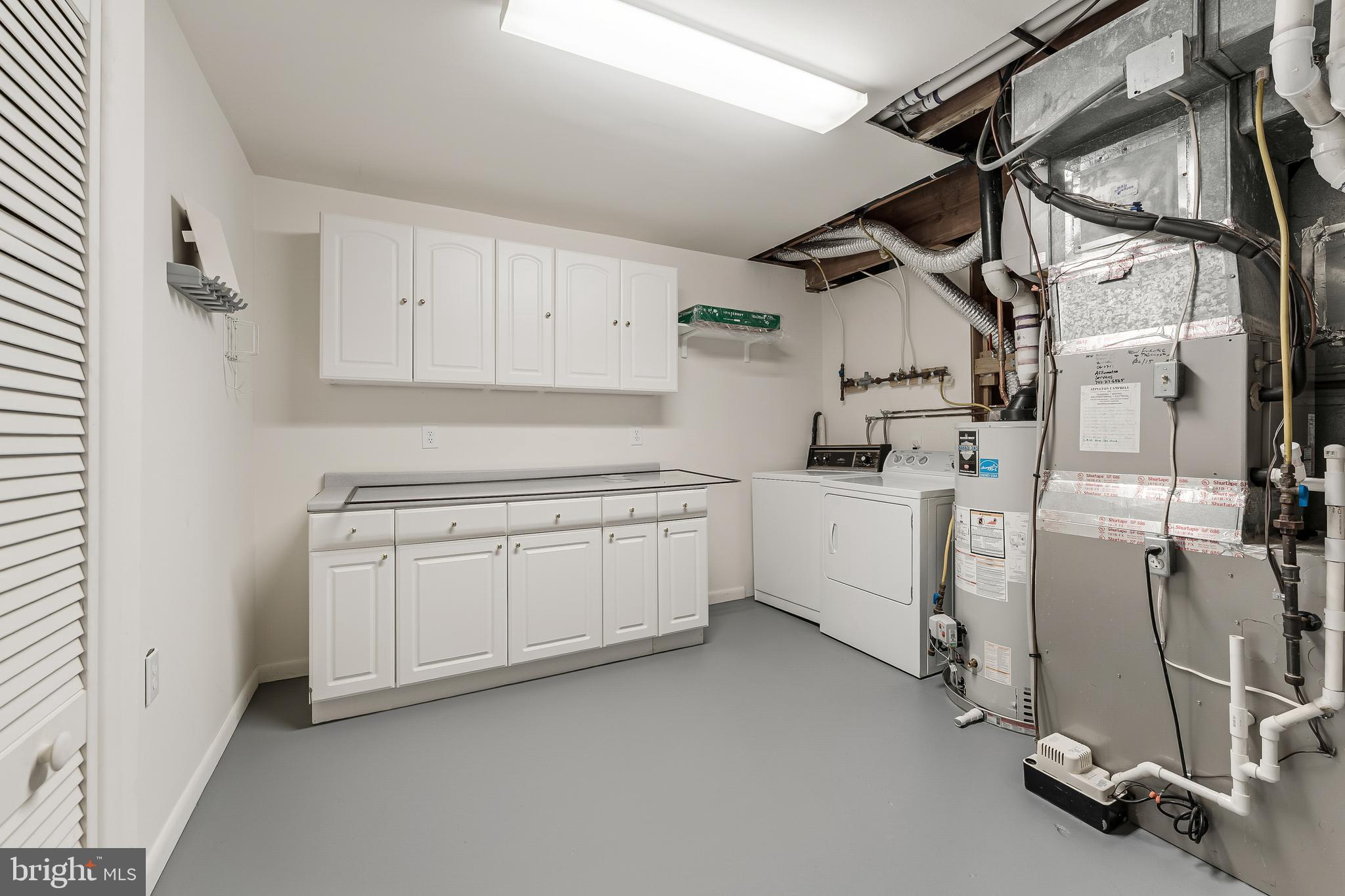 2261 Cedar Cove Court Reston, VA 20191 - Photo 69 of 102 a utility room with cabinets dryer and washer