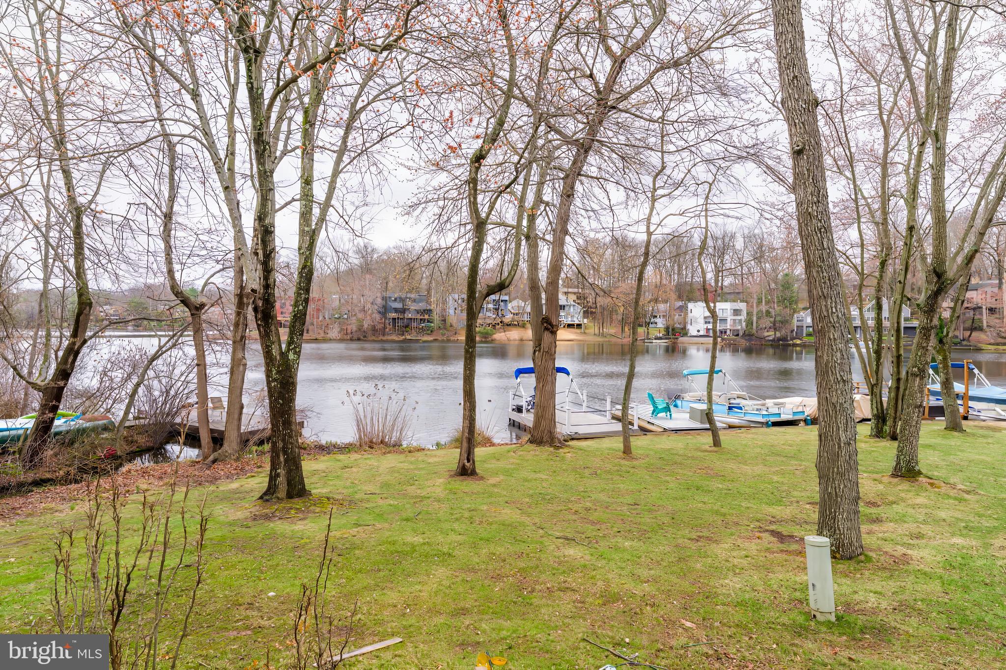 2261 Cedar Cove Court Reston, VA 20191 - Photo 71 of 102 a view of swimming pool with lawn chairs and large trees