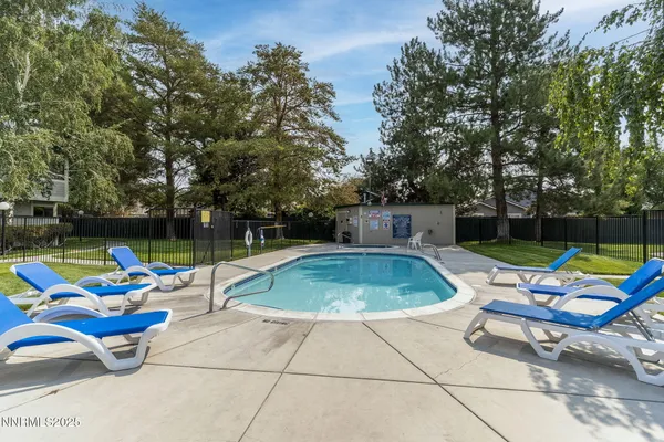 a view of outdoor space with swimming pool and furniture