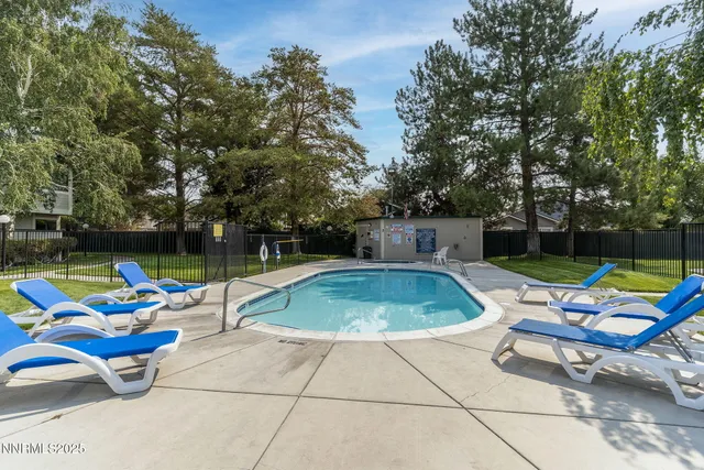 a view of outdoor space with swimming pool and furniture