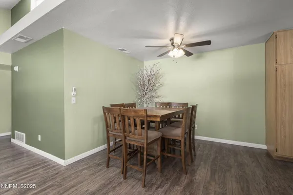a dining room with furniture and wooden floor
