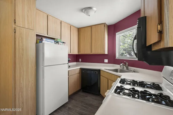 a kitchen with a refrigerator and a sink