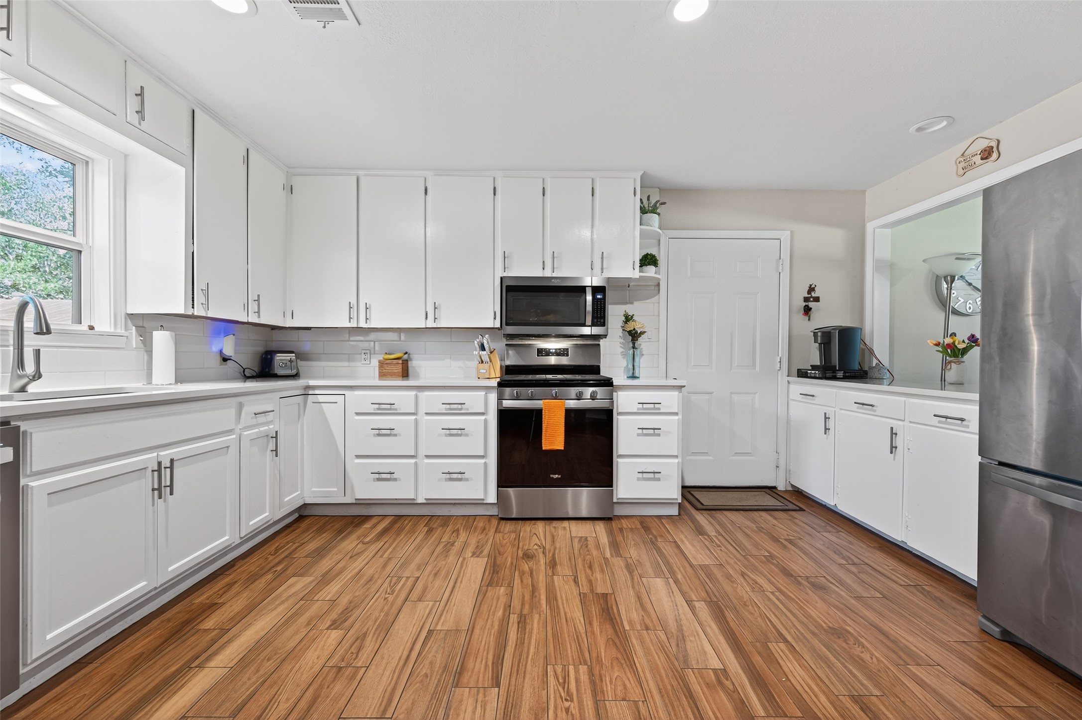 204 King Drive Columbus, TX 78934 - Photo 12 of 50 a kitchen with wooden floors appliances and cabinets