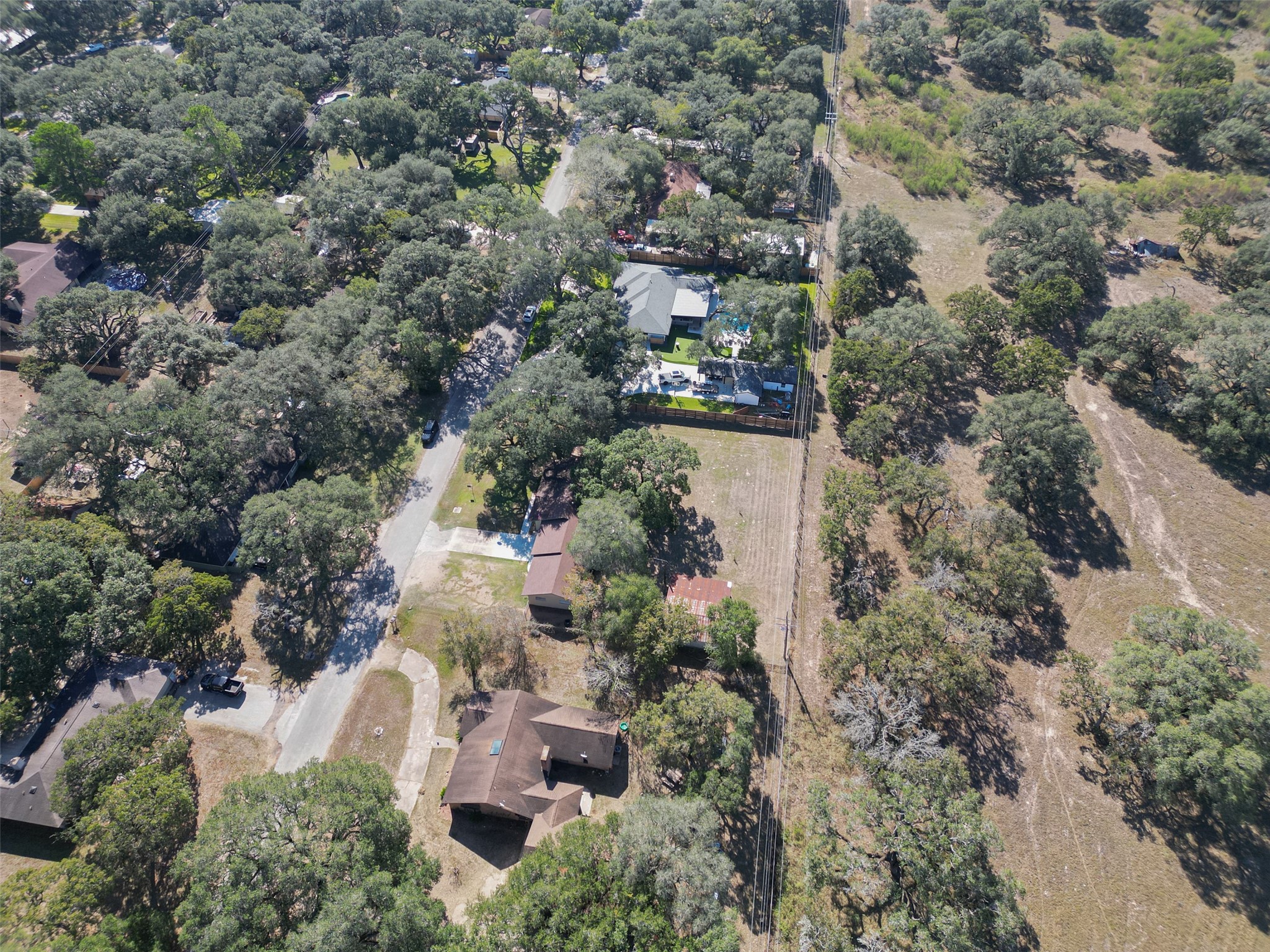 204 King Drive Columbus, TX 78934 - Photo 46 of 50 an aerial view of a house with a yard and large trees