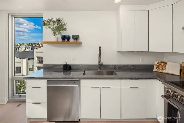 a kitchen with a refrigerator and a sink