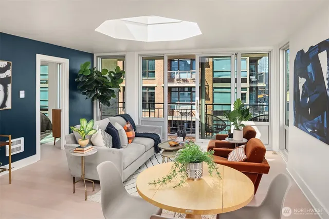 a living room with furniture and a potted plant