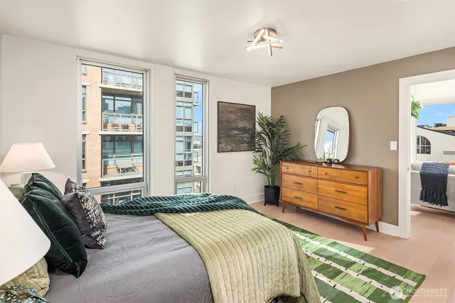 a bedroom with a bed and a lamp on table