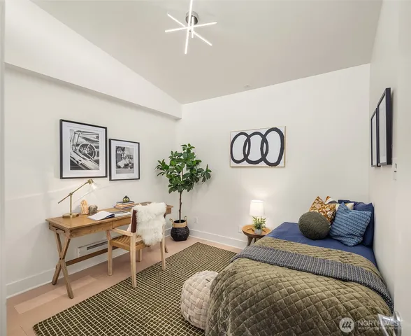 a bedroom with a bed and a potted plant