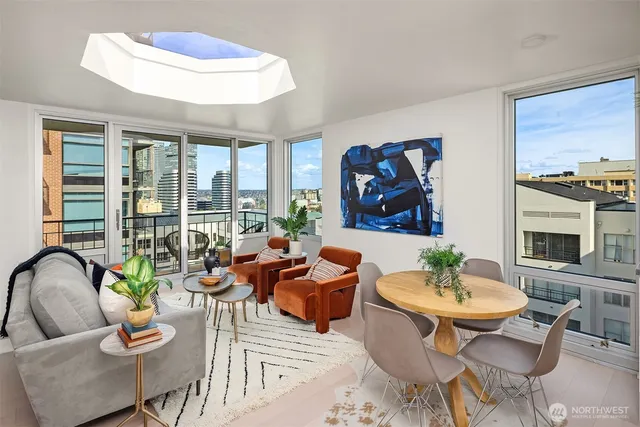 a living room filled with furniture and a potted plant