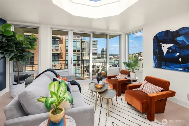 a living room with furniture and a potted plant