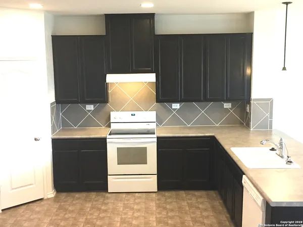 a kitchen with a sink and a stove