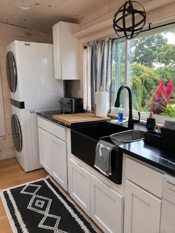 a kitchen with a sink appliances and cabinets