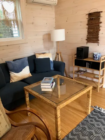 a kitchen with a table chairs and a wooden floor