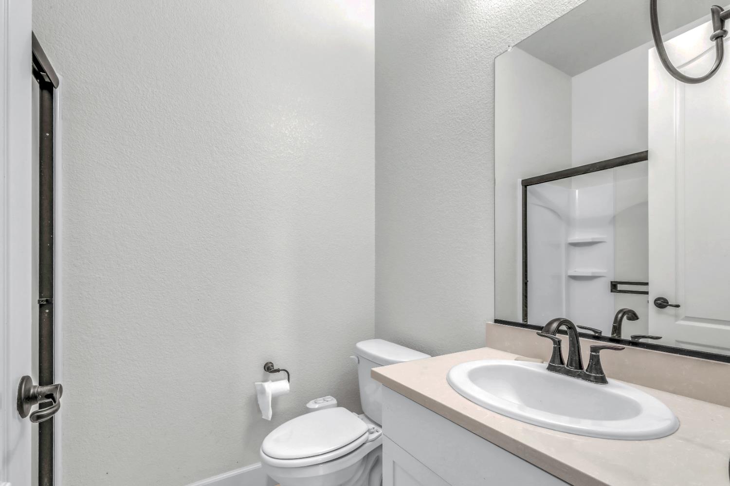 4129 Castellina Way Manteca, CA 95337 - Photo 18 of 58 a bathroom with a sink a toilet and a mirror