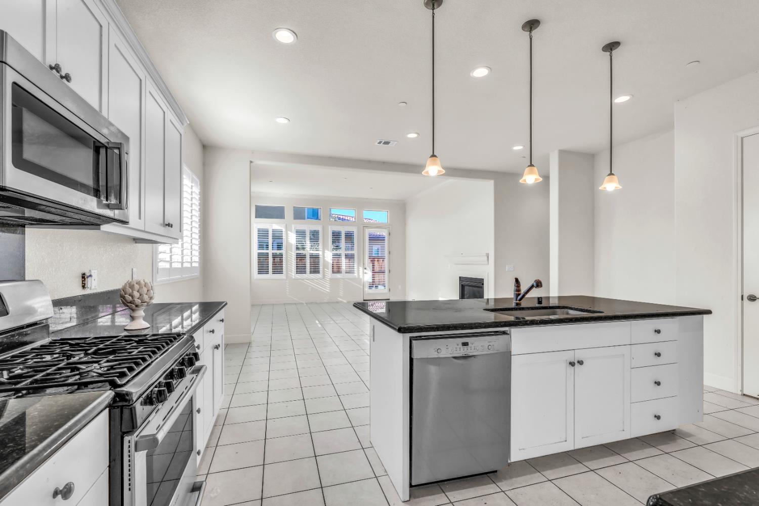 4129 Castellina Way Manteca, CA 95337 - Photo 28 of 58 a kitchen with a sink stove and microwave