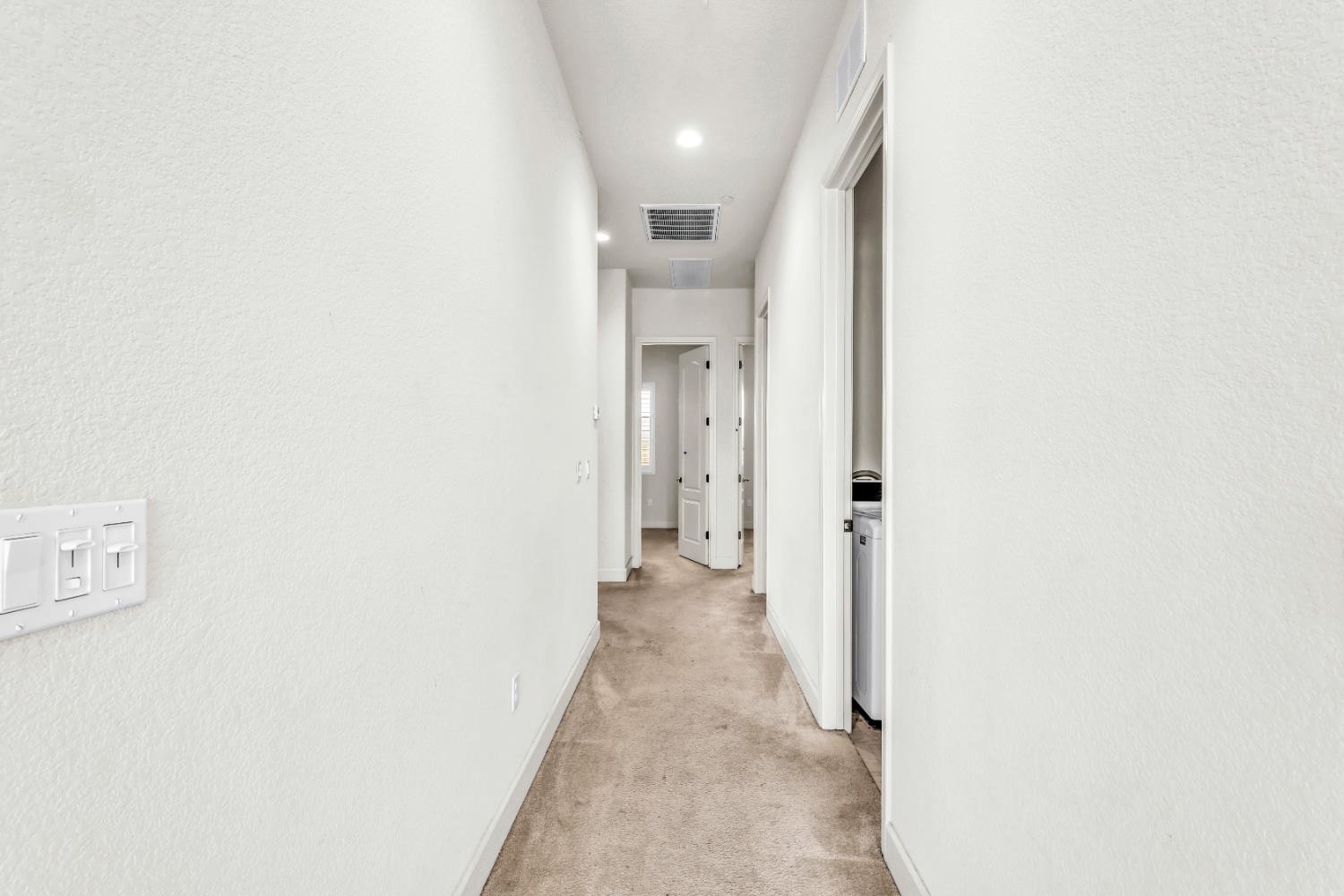 4129 Castellina Way Manteca, CA 95337 - Photo 31 of 58 a view of a hallway with wooden shelves