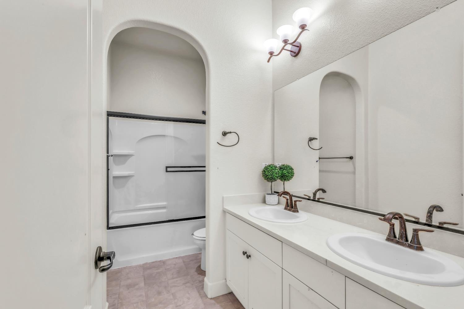 4129 Castellina Way Manteca, CA 95337 - Photo 34 of 58 a bathroom with a double vanity sink and a mirror