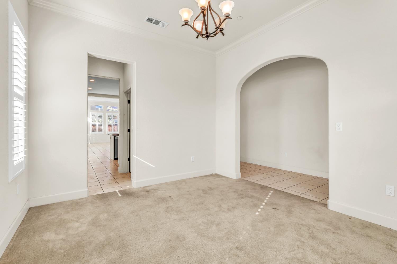 4129 Castellina Way Manteca, CA 95337 - Photo 9 of 58 an empty room with chandelier fan