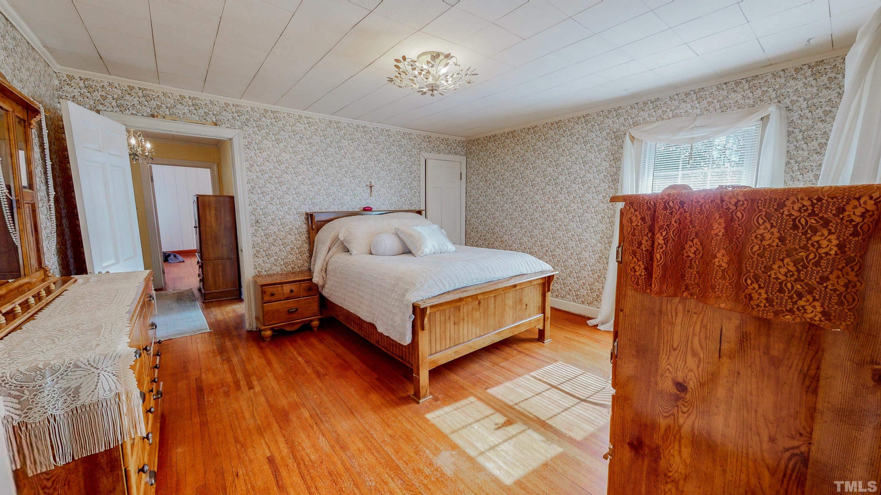 155 Hesters Store Road Roxboro, NC 27574 - Photo 14 of 77 a bedroom with a bed and a table in it