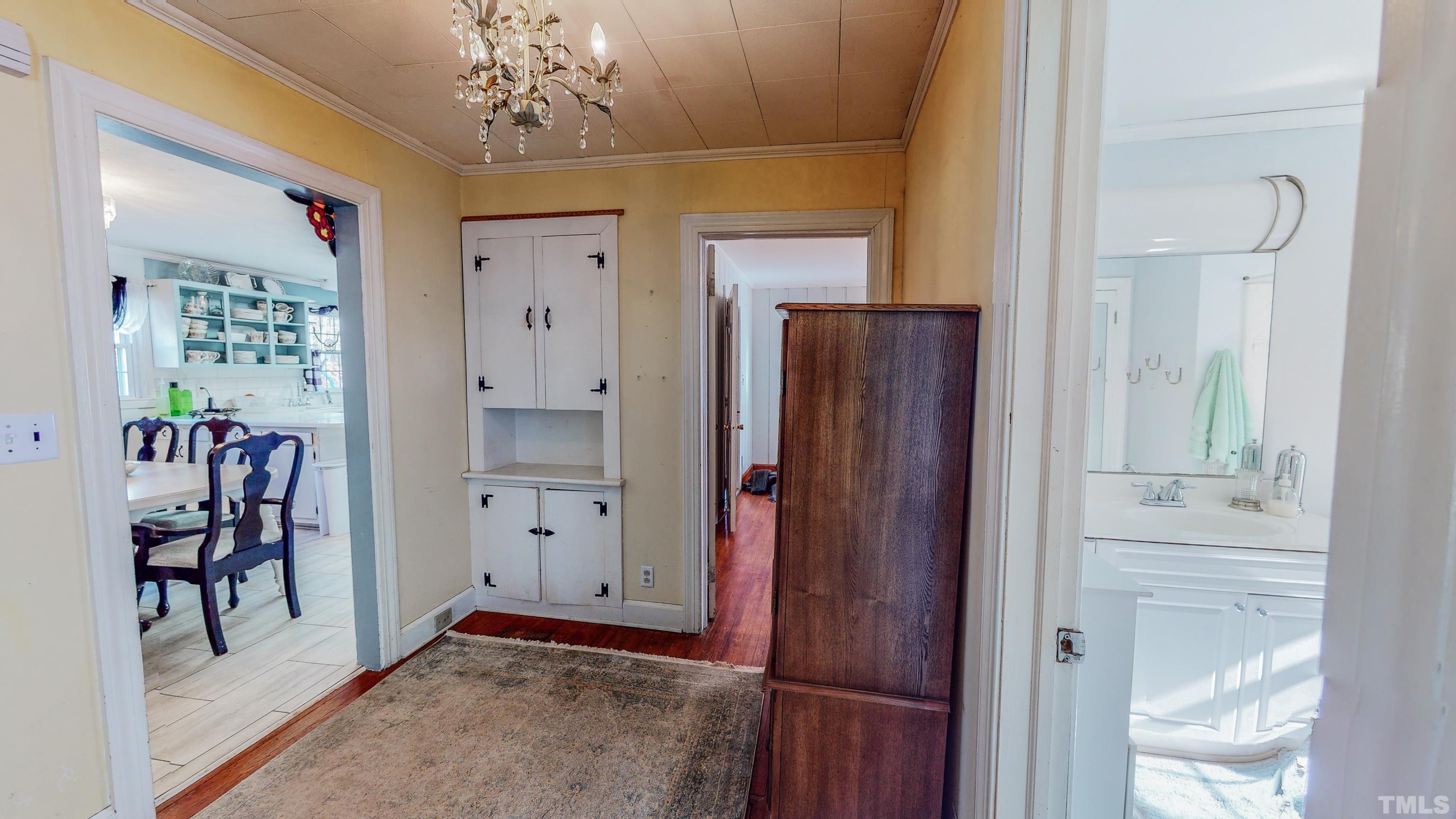 155 Hesters Store Road Roxboro, NC 27574 - Photo 16 of 77 a view of a hallway with dining area and chandelier