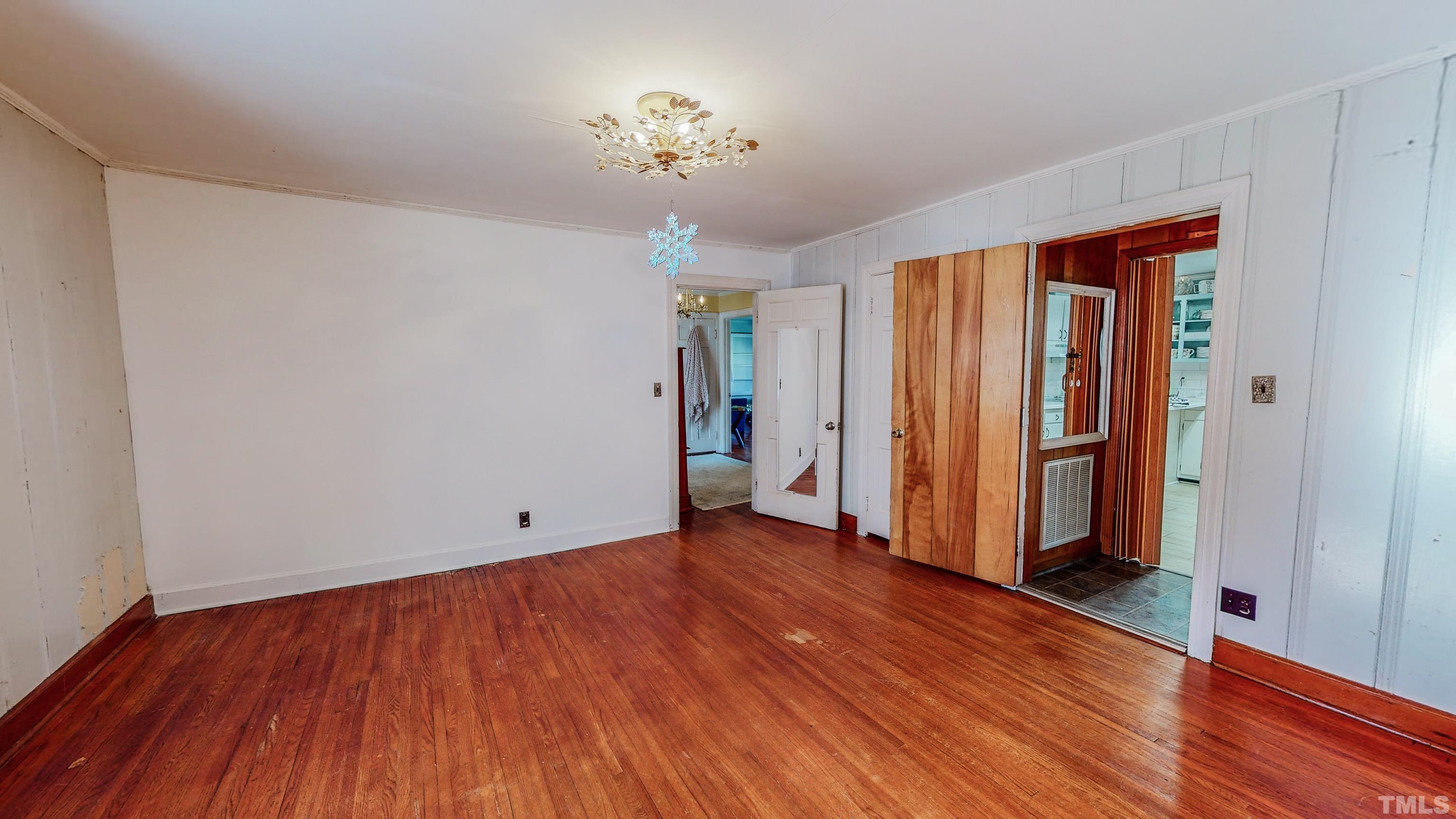 155 Hesters Store Road Roxboro, NC 27574 - Photo 25 of 77 an empty room with wooden floor and a window
