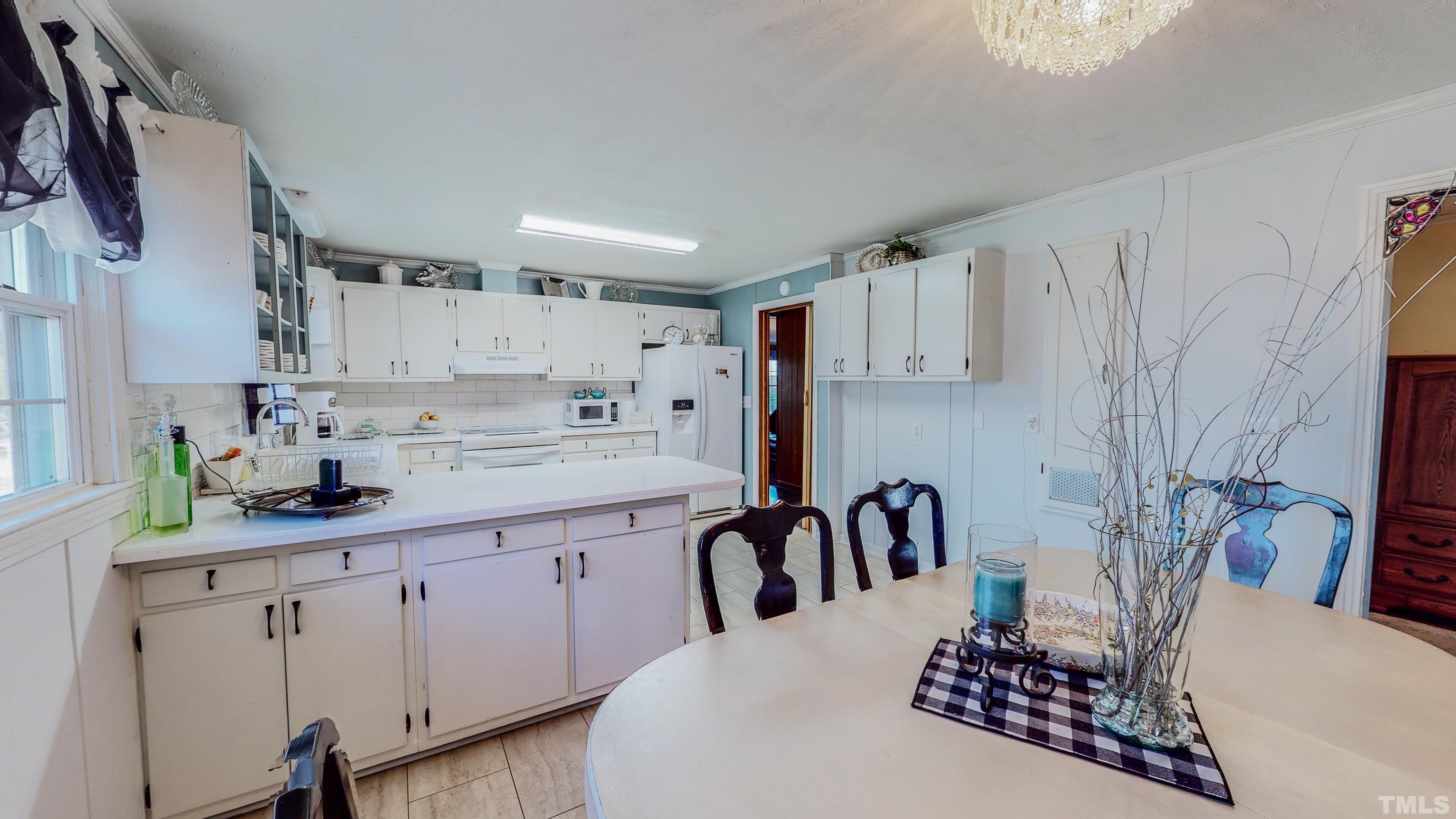 155 Hesters Store Road Roxboro, NC 27574 - Photo 44 of 77 a kitchen with stainless steel appliances a sink a stove a refrigerator and cabinets
